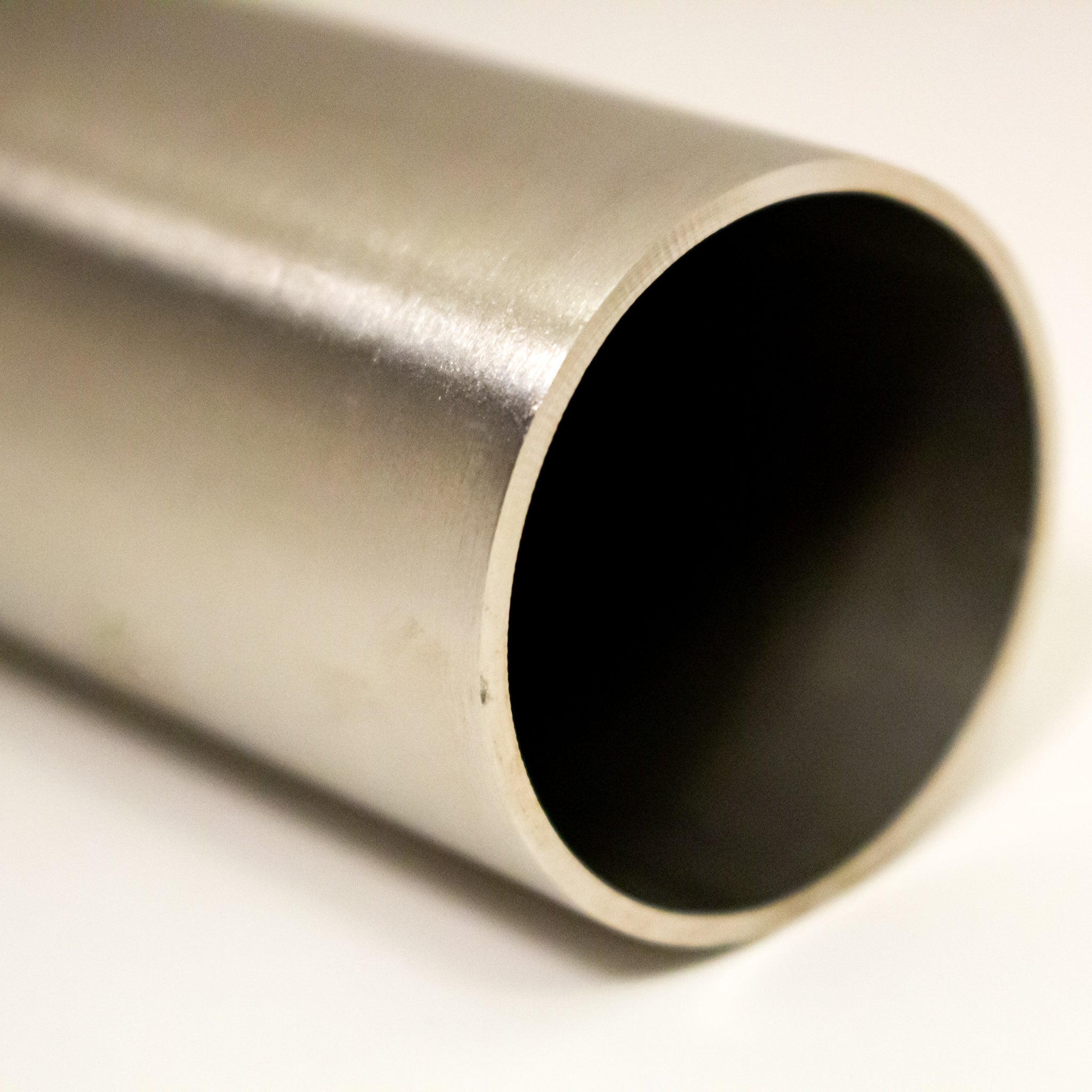 Single 304 stainless steel round tube cut to length showing satin polished finish and hollow end face