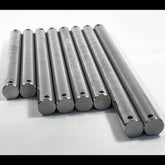 Multiple 316 stainless steel boat trailer roller spindles stacked at an angle on white background