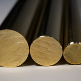 Close-up of three brass round bar end faces showing cut surface