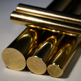Multiple polished brass round bars stacked showing reflective golden finish
