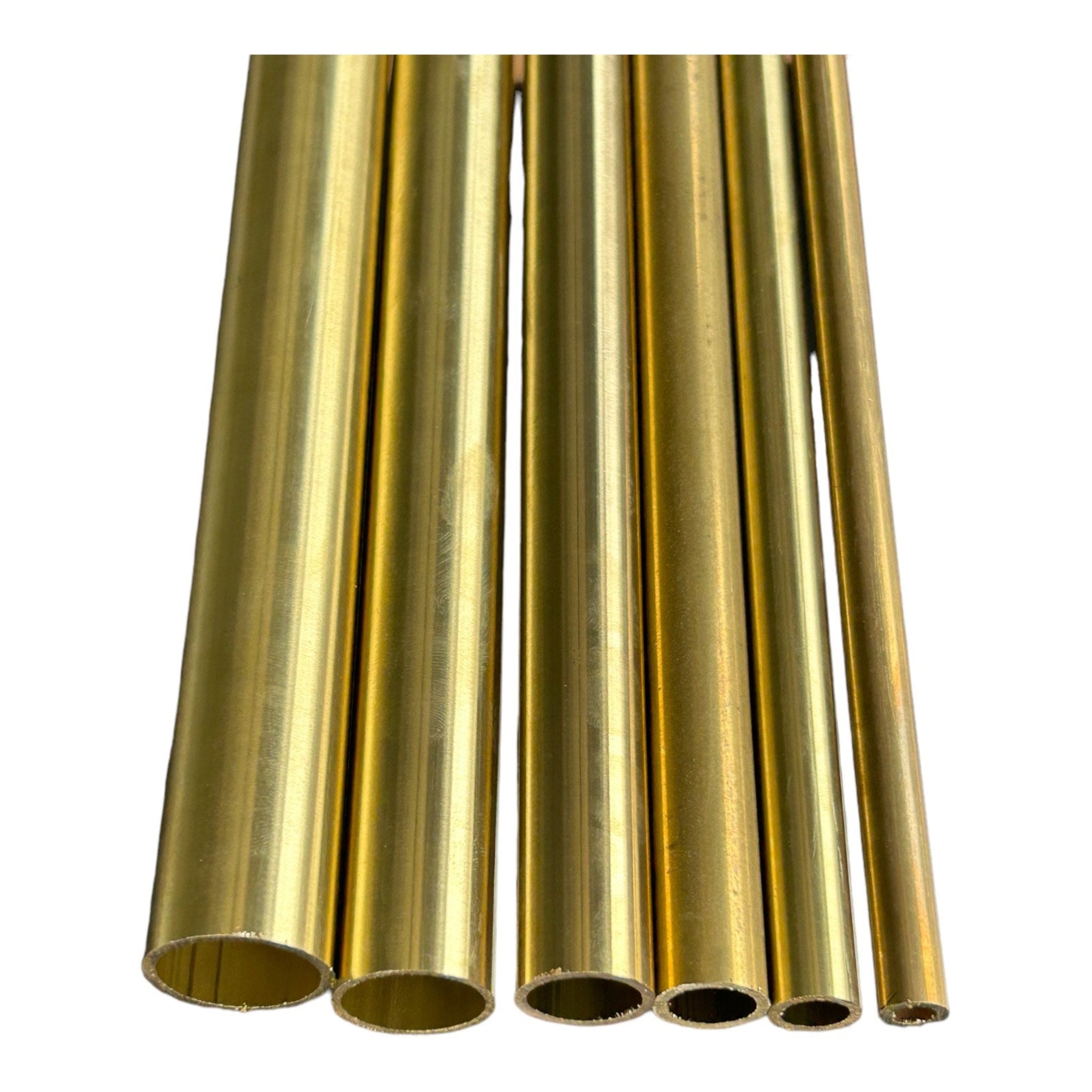 Five brass round tubes cut to length showing hollow ends and range of available diameters on white background