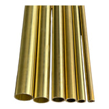 Five brass round tubes cut to length showing hollow ends and range of available diameters on white background
