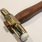 Hammer with wooden handle and metallic head on a white background