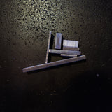 different size Stainless Steel Flat bar pieces arranged and photographed on a dark textured surface under direct light.
