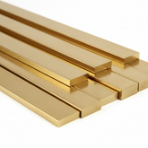 polished Brass metal bars arranged in a fan-like stack on a clean white background.