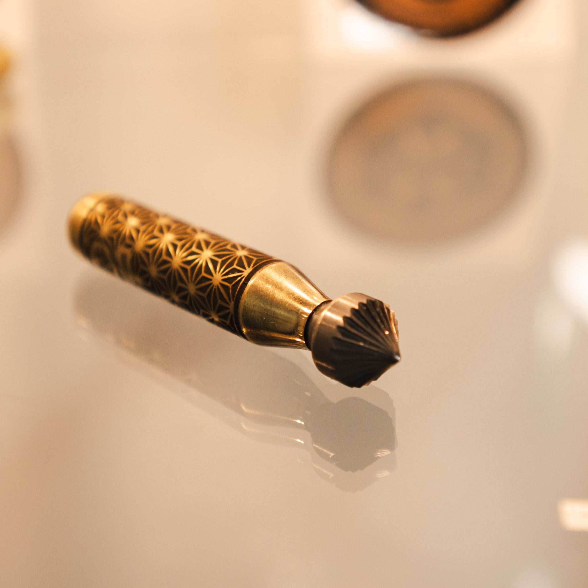 this lovely brass deburring tool shining under the light giving off a gold visual 