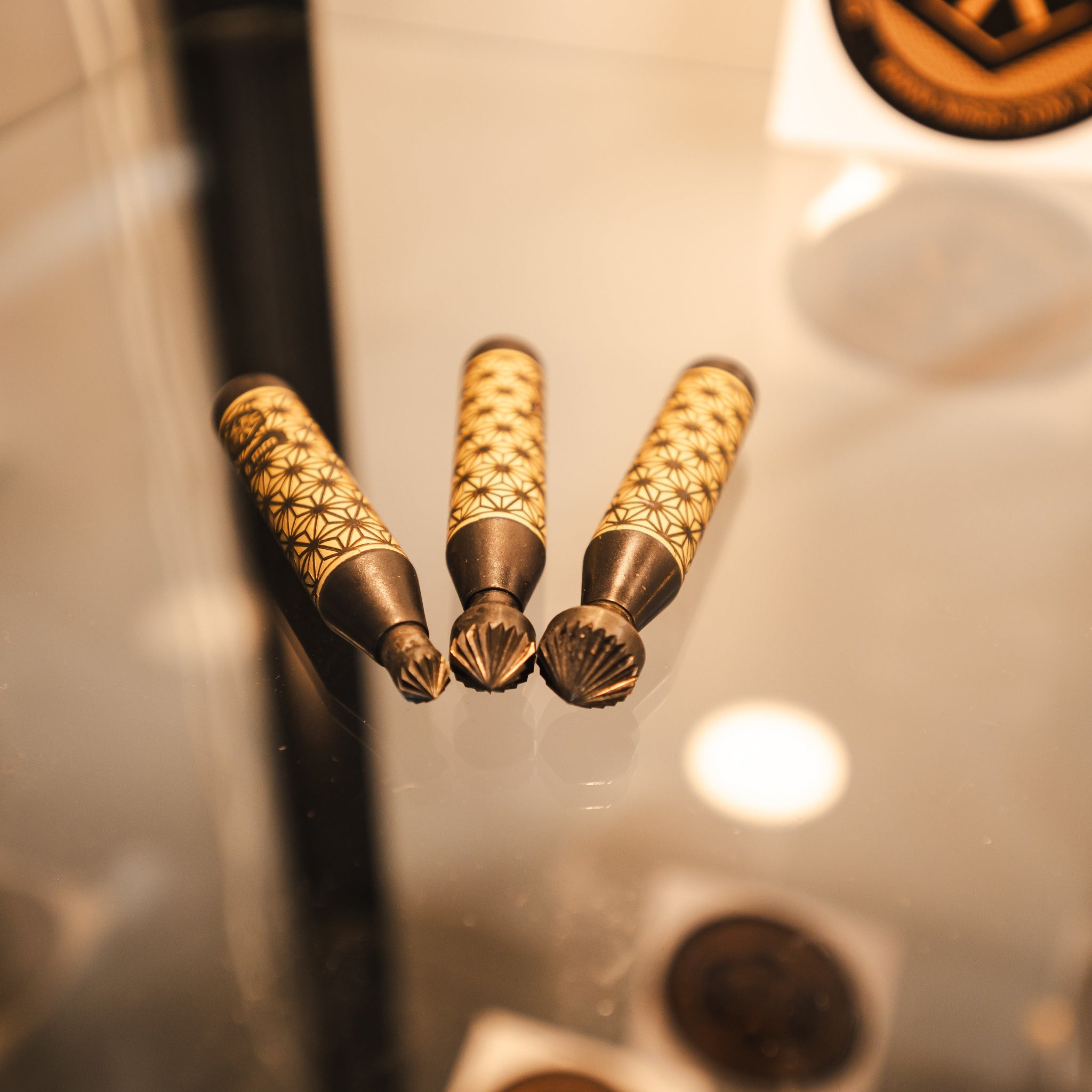 a set of 3 deburring tools that are blackened brass with Kumiko engraving 