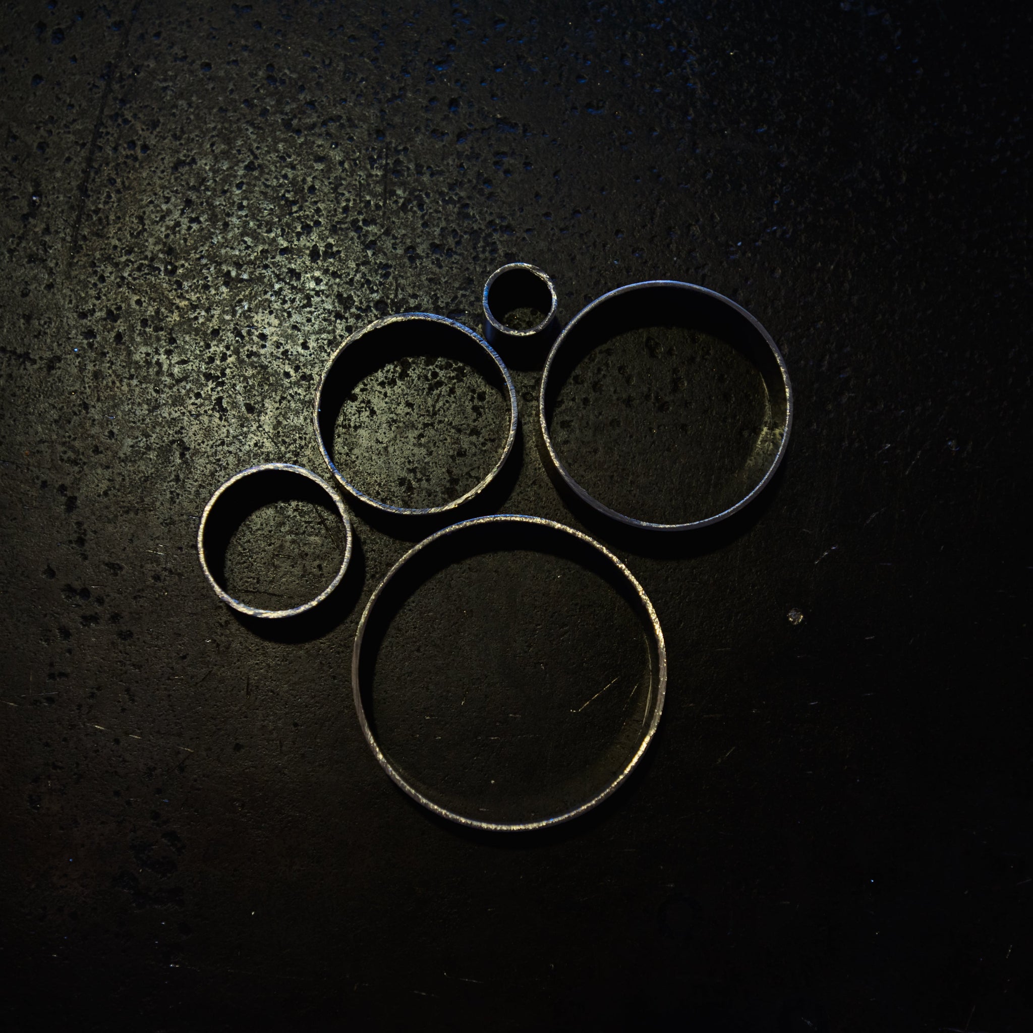 Angled view of 304 stainless steel round tube cut sections showing hollow ends and wall thickness across multiple diameters