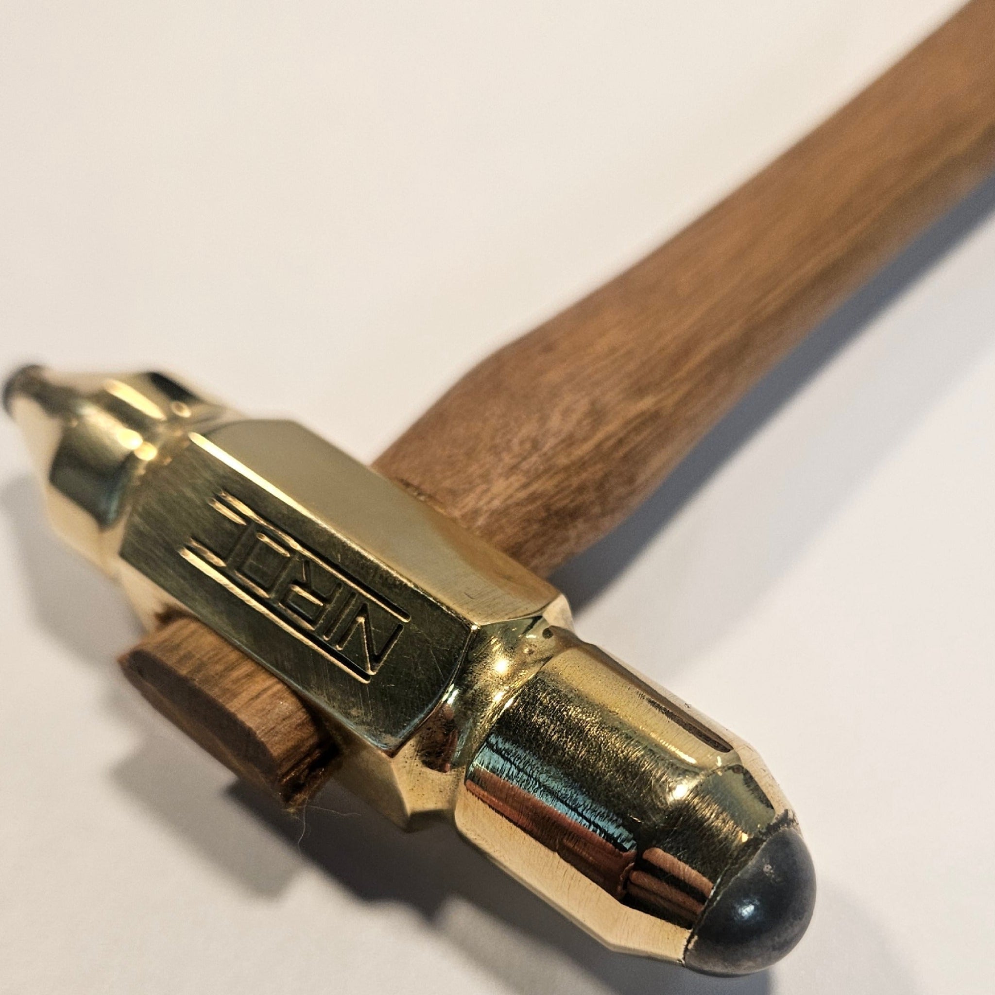 small brass head hammer with carbide ball heads and wooden handle 