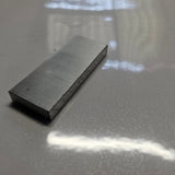 aluminium 6mm x 50mm on a shinny  white background on a downward angled view