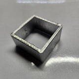 aluminium square object on a reflective surface