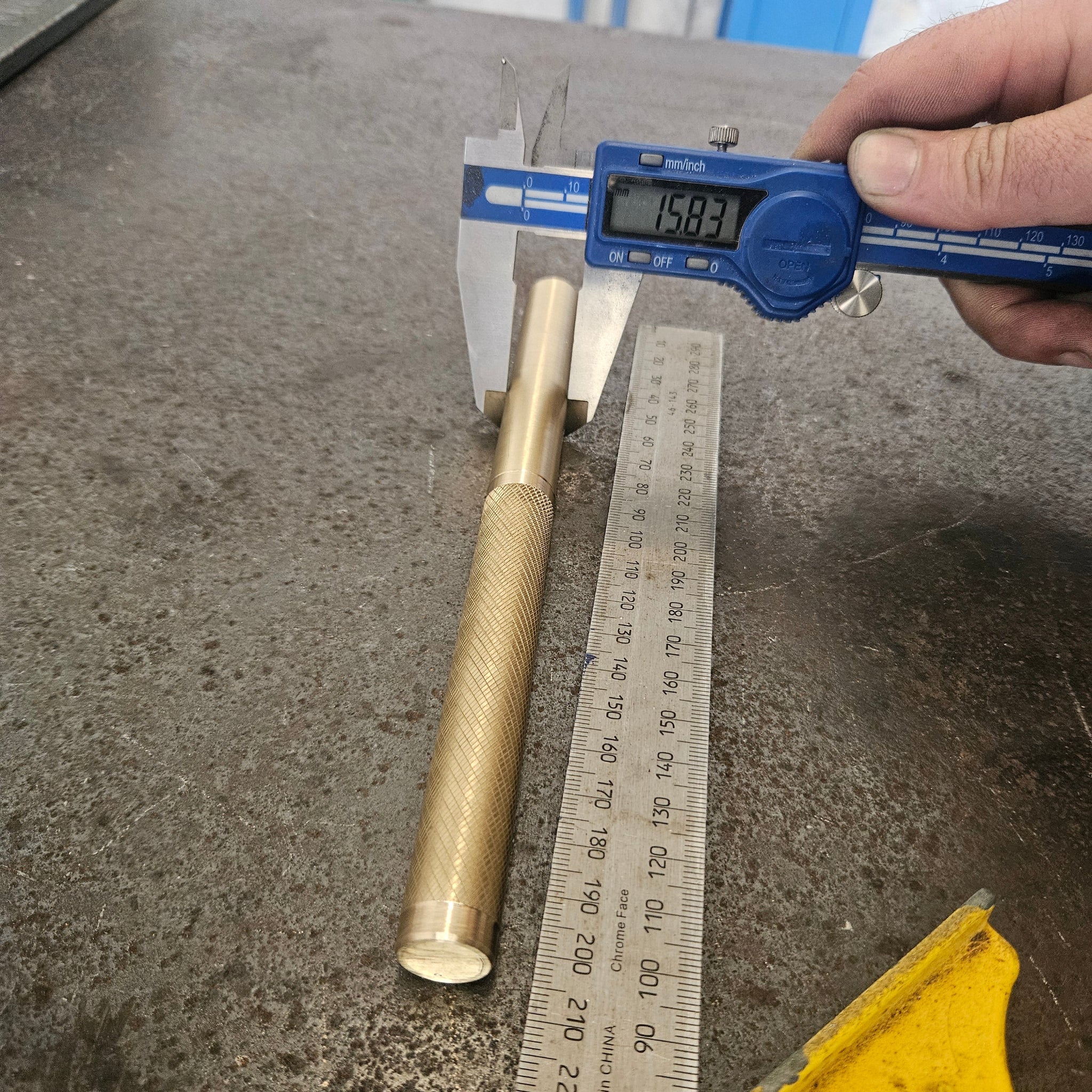 brass drift being measured on a steel bench 