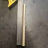 brass drift with knurled handle on a steel bench 