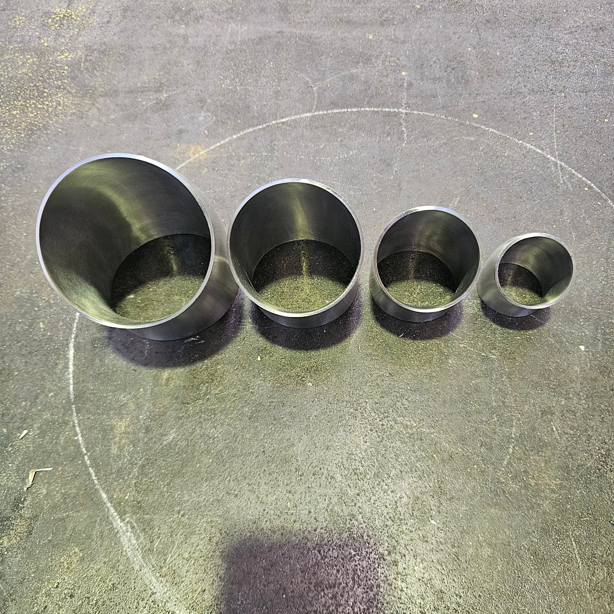 a top view of 4 45 degree bends standing on a steel bench