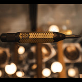 blackened brass auto punch with a star pattern engraved to the body