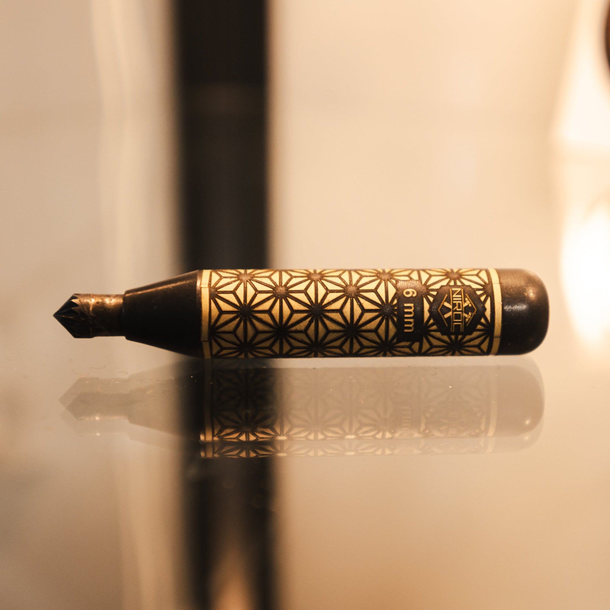 a close up view of this lovely brass deburring tool with blackened brass and Kumiko pattern 